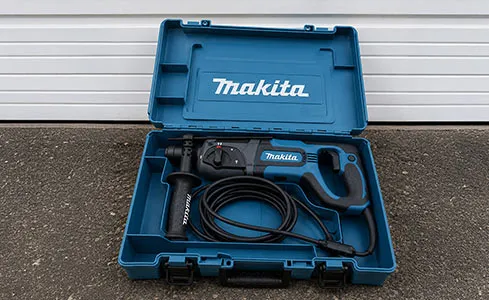Rotary Hammer - Makita power tool case on concrete