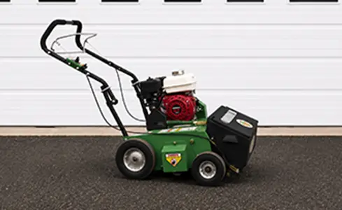 Seeder - Green turf machine against white garage door
