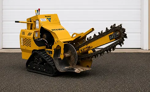 Trencher - Yellow Vermeer trencher against garage door