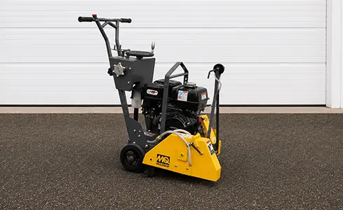 Walk Behind Concrete Saw - Industrial concrete cutter in front of garage
